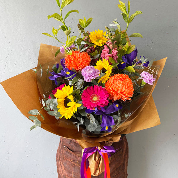 A Touch of Colour sympathy bouquet with bright seasonal flowers by Cyril Cooke Florists Geelong