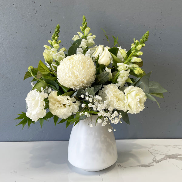 White flower arrangement in ceramic vase by Cyril Cooke Florists Geelong